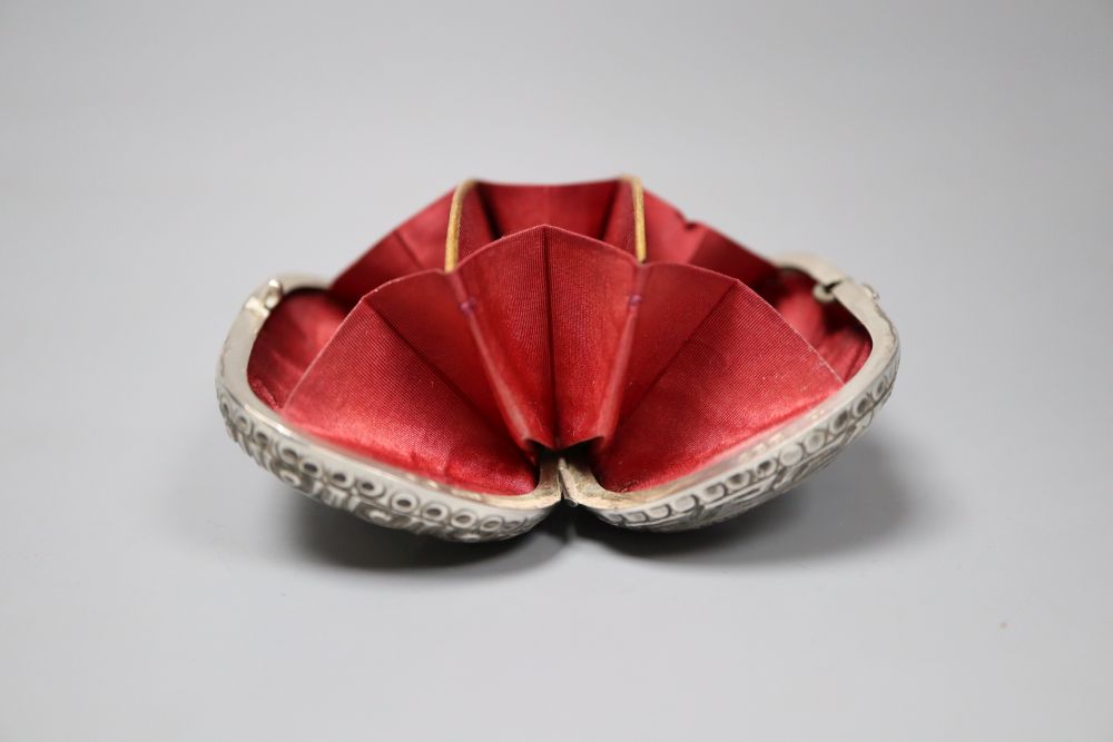 A Victorian silver mounted ovoid purse, decorated with Greek busts, Levy & Salaman, Birmingham, 1884, 72mm.